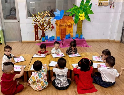 Các bé nhóm 13-24 tháng trong giờ học tạo hình  Ấn dẹt tạo cánh hoa đào 